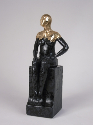 Seated female nude on plinth by 