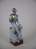 Seated male nude on plinth